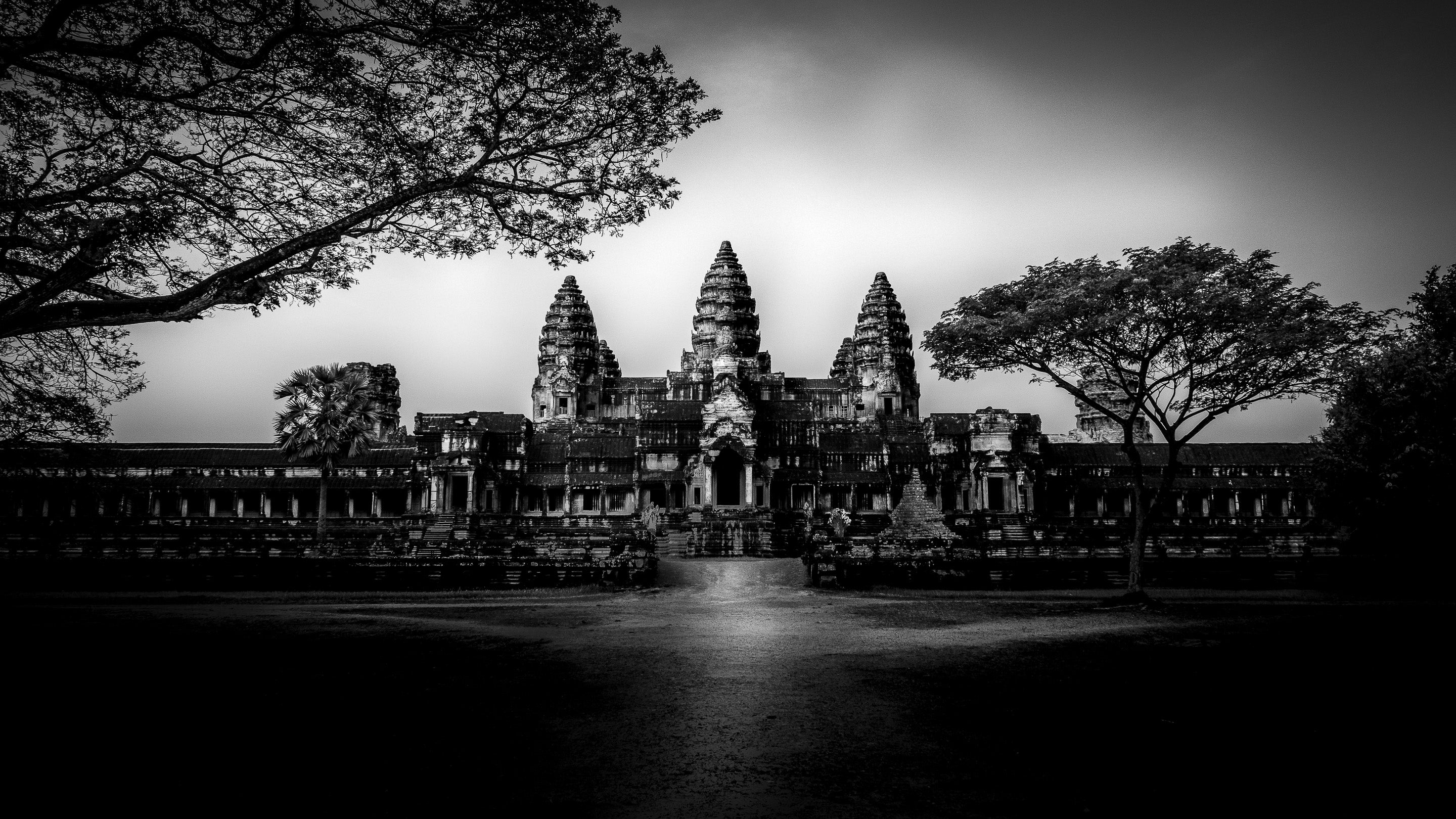 High-contrast black and white architectural photograph of Angkor Wat temple in Cambodia, capturing the raw reality of Rogue Anthropology's cultural immersion.